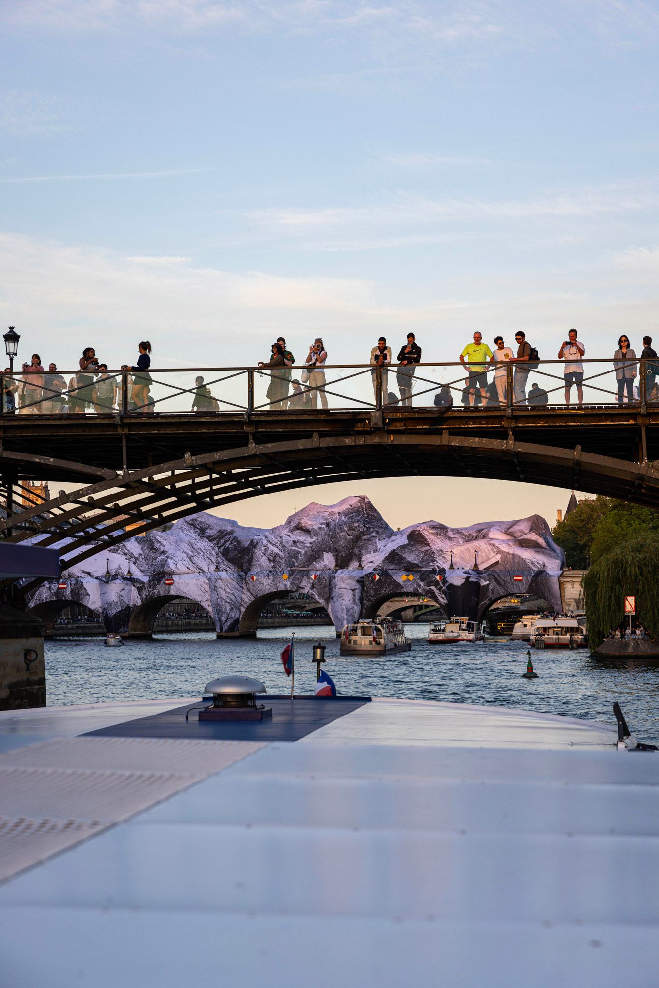 Pont Neuf couvert d'une installation monumentale en trompe-l'oeil vue depuis la Seine
